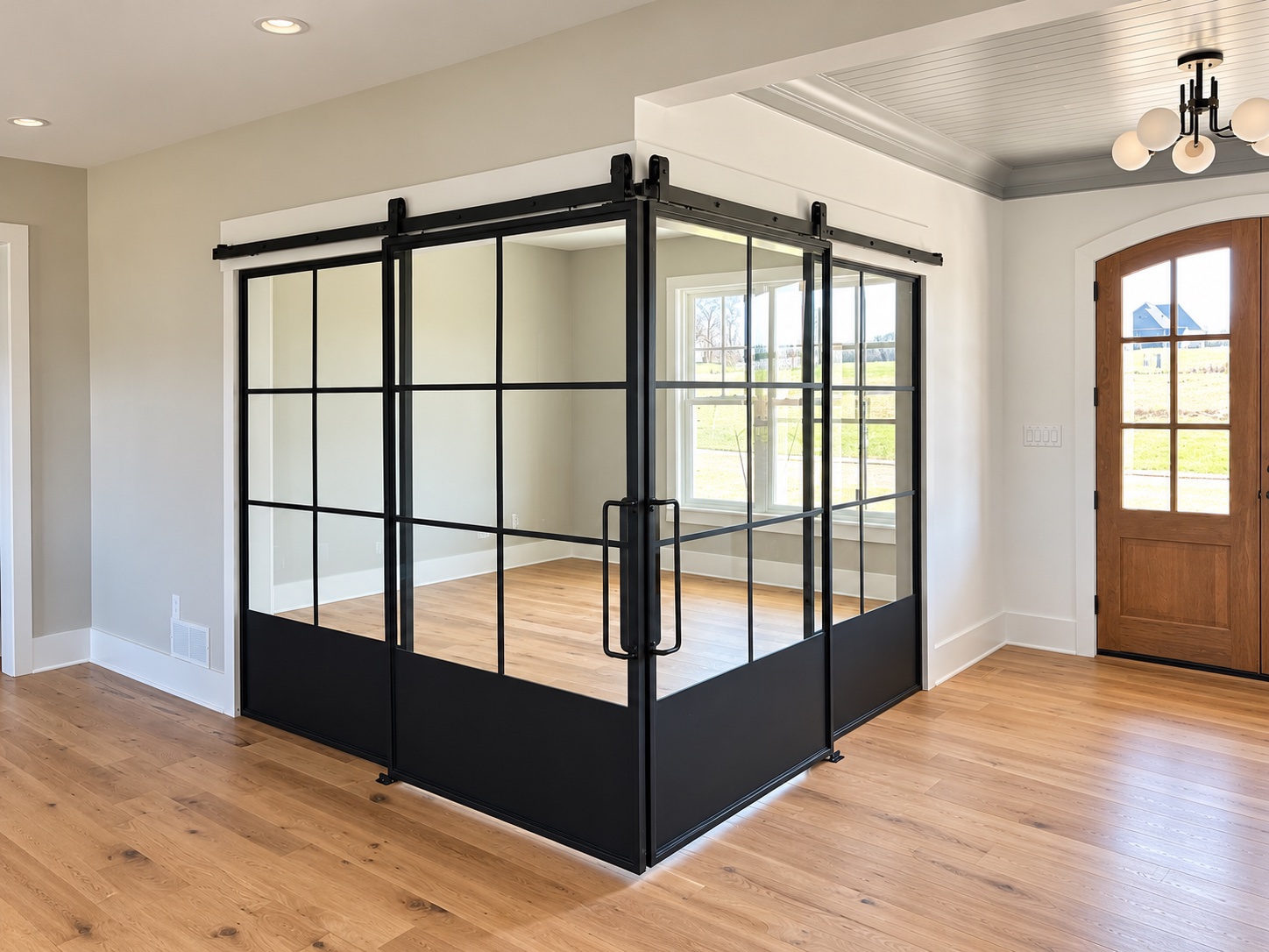 Black framed glass sliding doors meeting at a corner, with white trim and a wood ceiling beyond